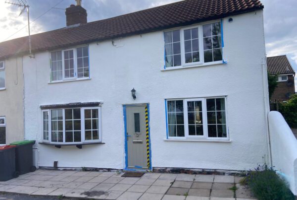 A cottage has it's walls repaired and protected by Home Fixology.