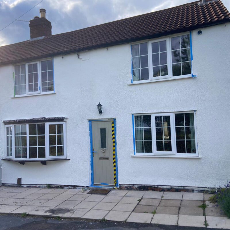 A cottage has it's walls repaired and protected by Home Fixology.