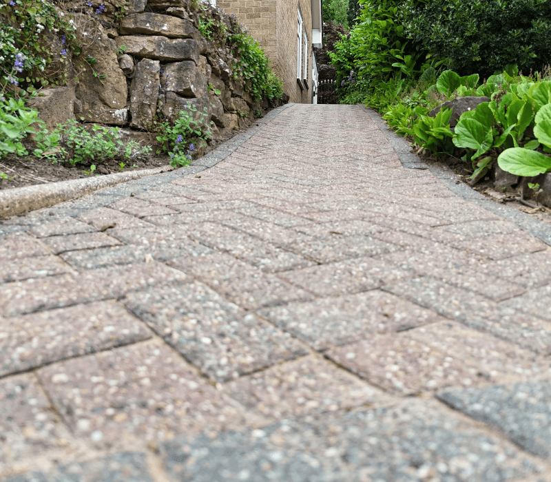 A pathway is protected from grime, stains, deposits, weeds and sand loss after a driveway restoration with Resiblock