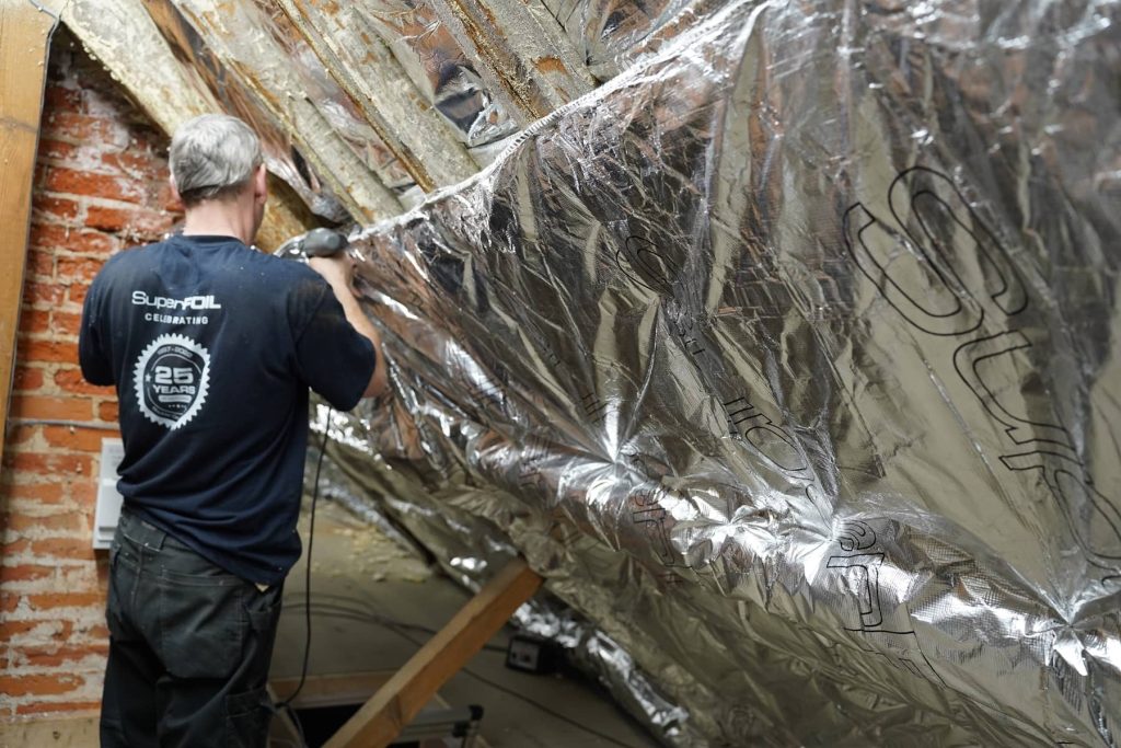 Super Foil Insulation being expertly installed by Home Fixology into a roof space.